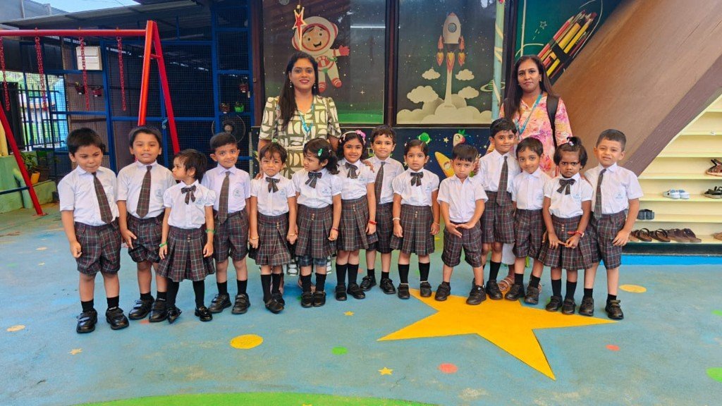 Galaxy Infant School class with teachers posing outdoors on the campus playground