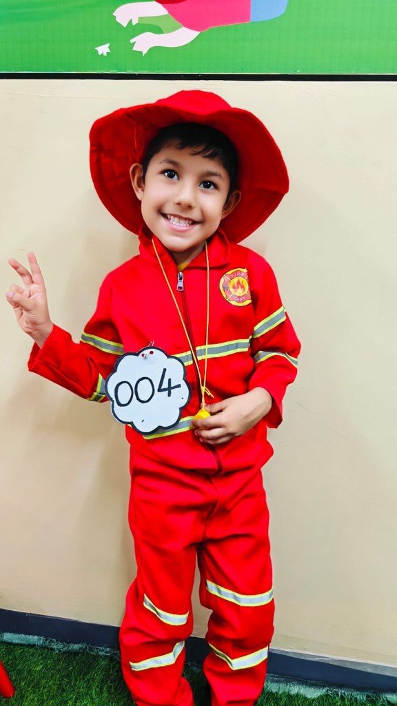 Child in firefighter costume at Galaxy Infant School