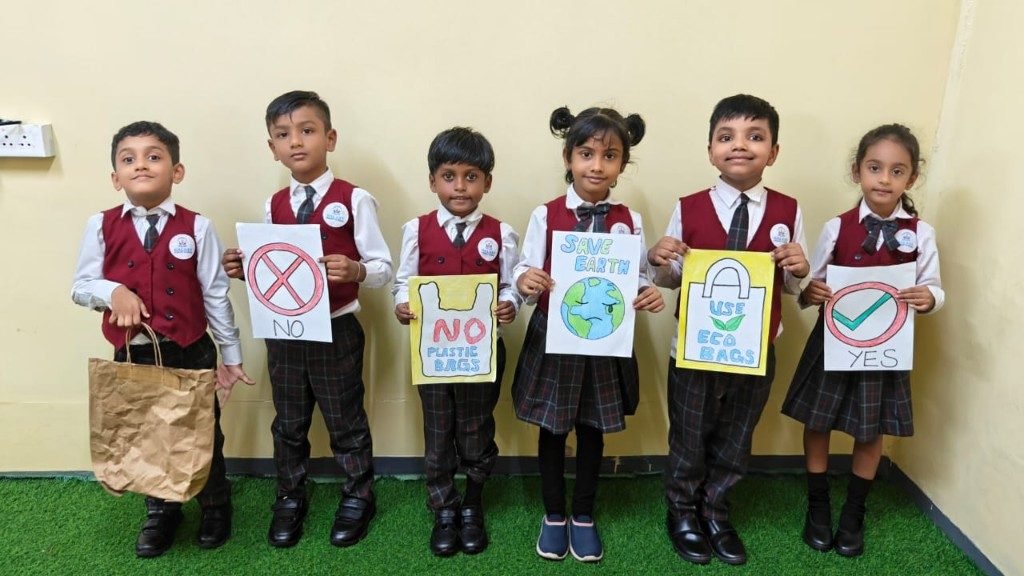 Students holding Save Earth and eco bag awareness posters during Fun Day learning