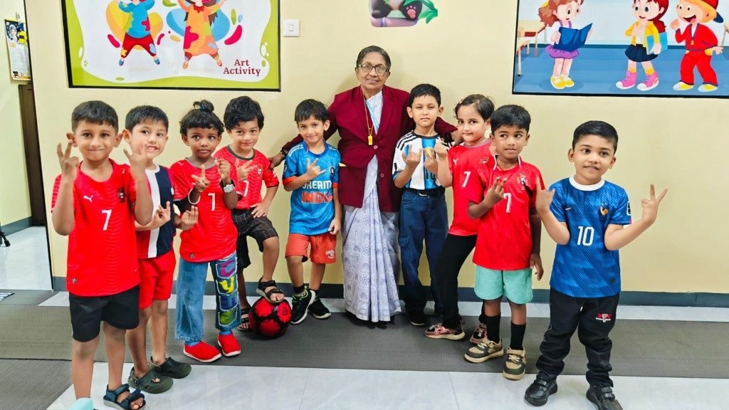 UKG class sports day group photo with peace signs and teacher
